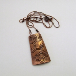Carved copper pendant